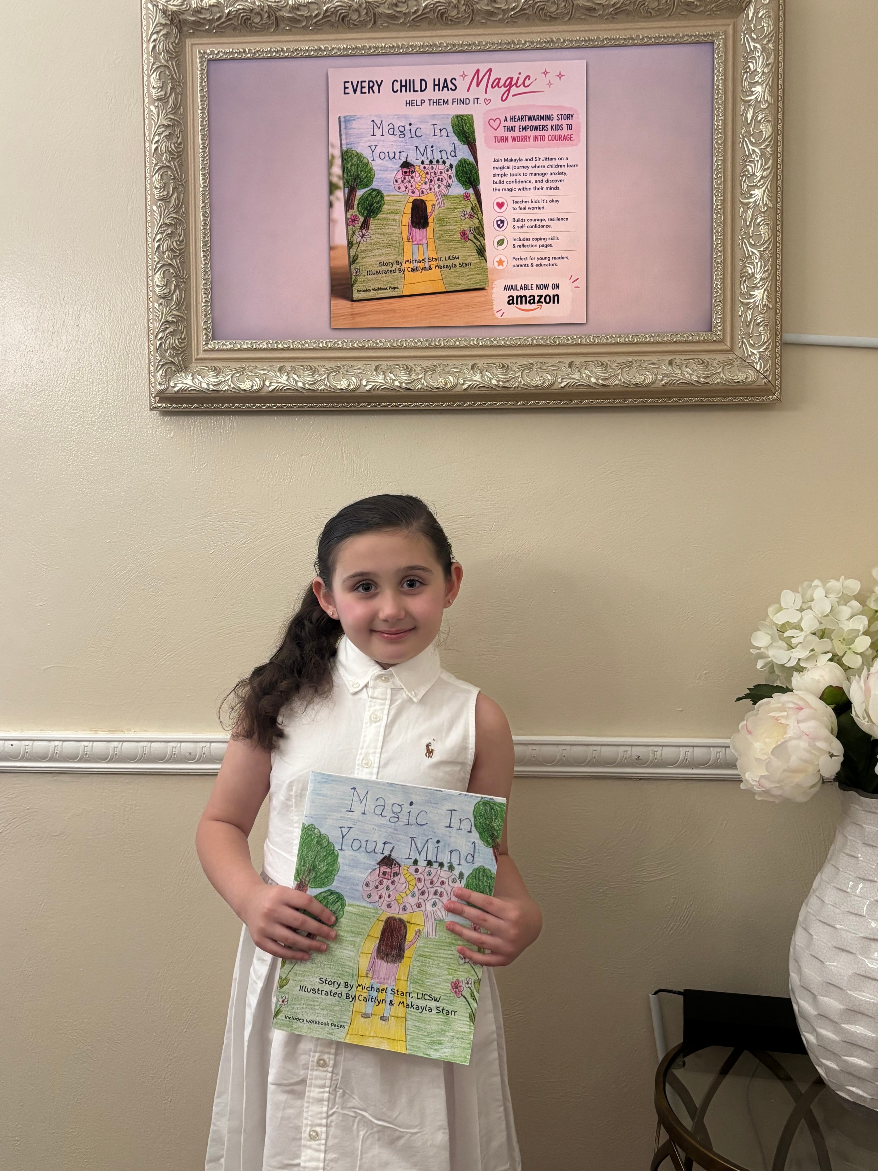 Makayla Starr holding the book Magic In Your Mind